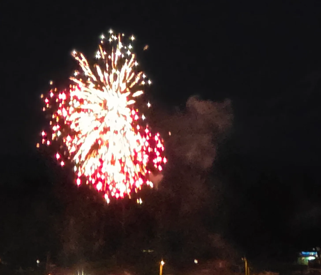 Bright fireworks lighting up the night sky with vibrant colors