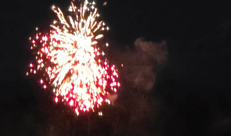 Bright fireworks lighting up the night sky with vibrant colors