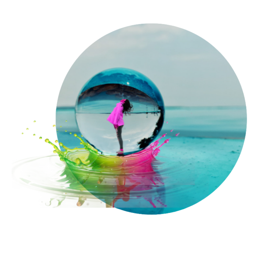 Colorful beach reflection captured in a glass sphere on shore
