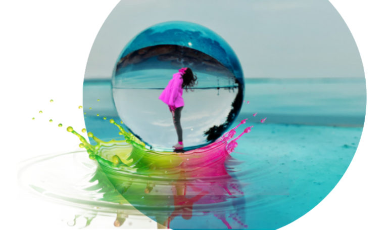 Colorful beach reflection captured in a glass sphere on shore
