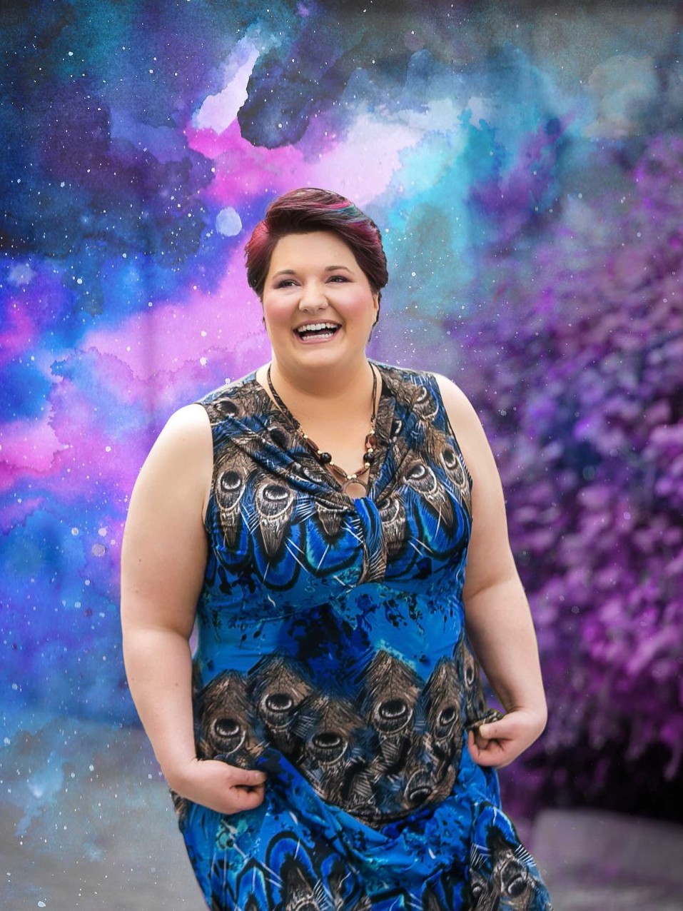 A picture of Shaneh Woods in a blue dress with a artistic cosmic background