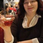 Woman enjoying a drink at a cozy restaurant setting