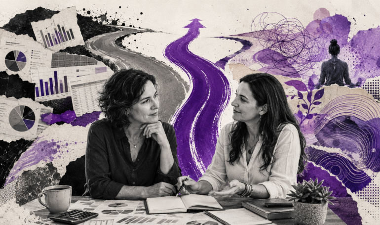 Two women discussing business strategies at a creative desk